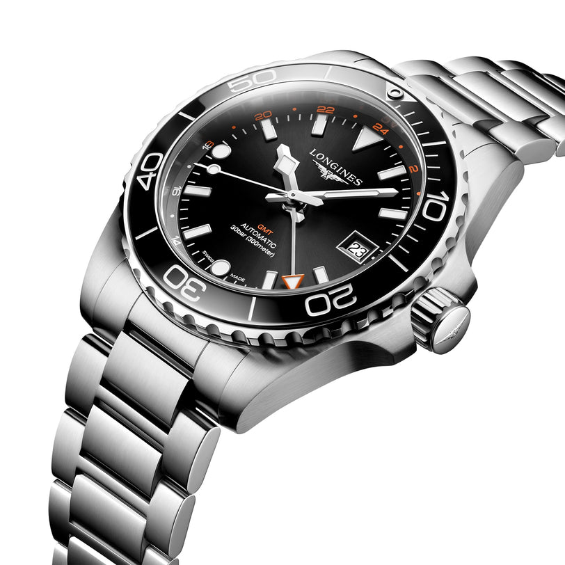 The Longines HydroConquest GMT, a stainless steel diving watch with a black dial, date display, and rotating bezel, is shown at an angle on a white background.