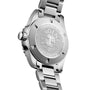 The image displays the back of the Longines HydroConquest, highlighting engraved branding and specifications on its sturdy stainless steel case.