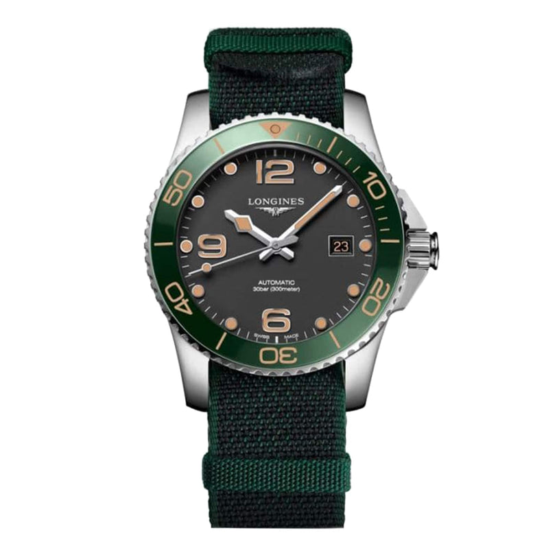 The Longines HydroConquest wristwatch features automatic movement, a green bezel, black dial, date display, and a green fabric strap, displayed on a white background.