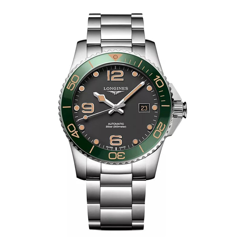 The Longines HydroConquest features a stainless steel case, green ceramic bezel, black dial with date at 3 oclock, and a silver bracelet.