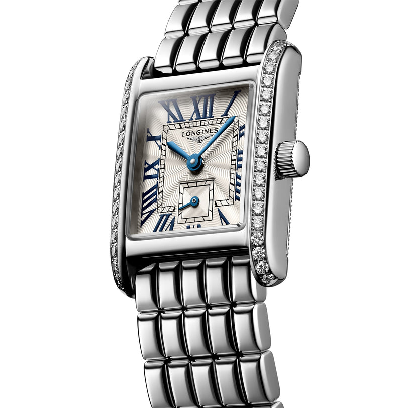 The Longines Mini DolceVita features a silver rectangular case, blue Roman numerals and hands, Top Wesselton diamond accents, and a stainless steel link bracelet.