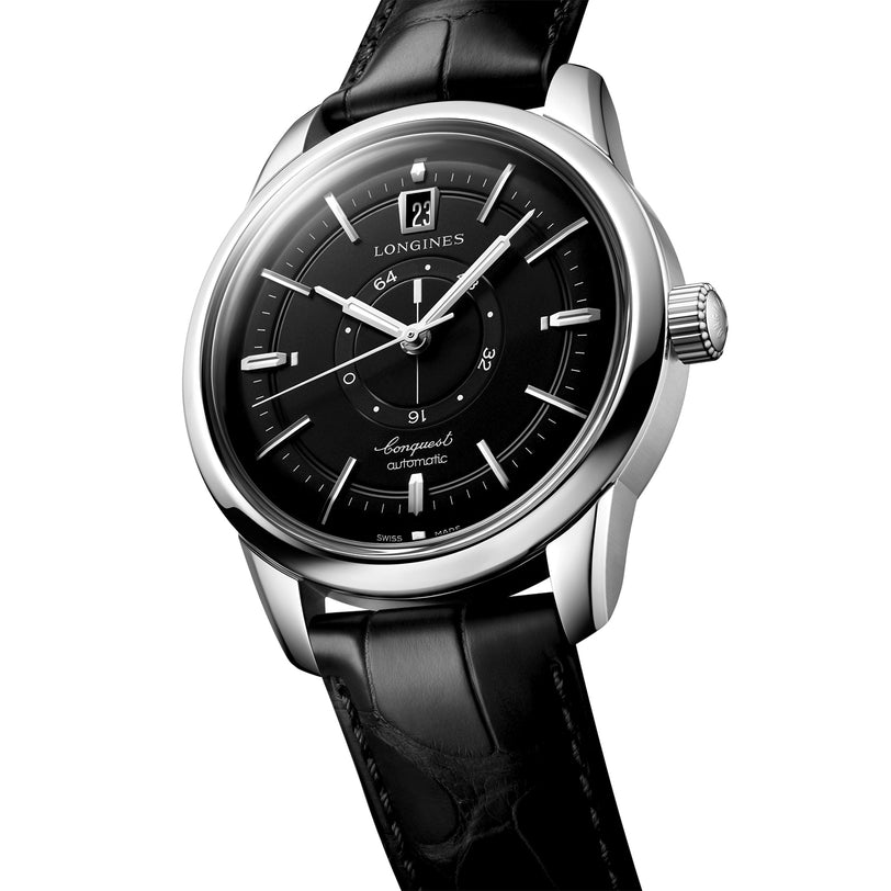 The Longines Conquest Heritage Central Power Reserve is an automatic watch featuring a black dial, silver markers, date display at 12 o’clock, stainless steel case, and a black leather strap.