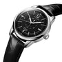 The Longines Conquest Heritage Central Power Reserve features a black dial with date display, stainless steel case, silver hour markers, and a black leather strap, shown at an angle.