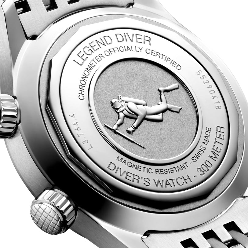 Close-up of the stainless steel case back of the Longines Legend Diver, engraved with a diver motif and inscriptions emphasizing its water resistance, anti-magnetic properties, certification, and model information.