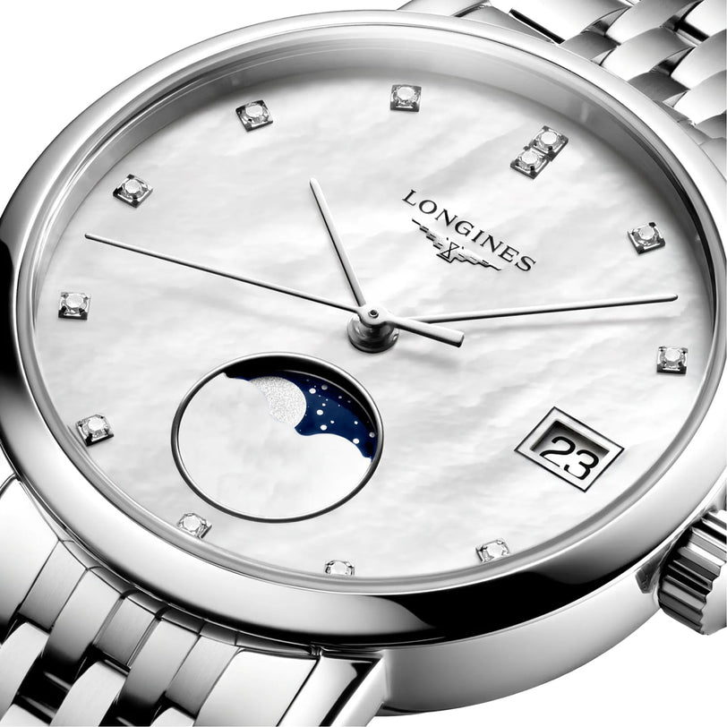 Close-up of the Longines Elegant Collection Moonphase watch, showcasing a white dial with diamond indexes, date display, moonphase indicator, and a silver metal bracelet.