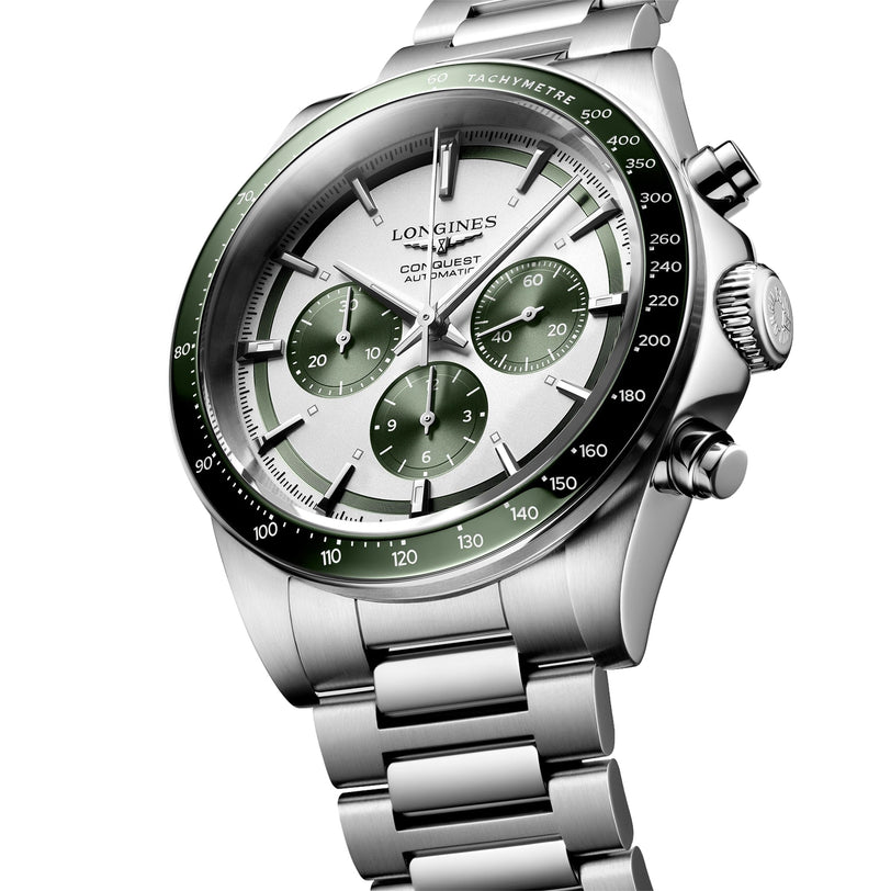 The Longines Conquest Chronograph features a stainless steel case, green bezel and subdials, silver dial, metal bracelet, and precise self-winding movement.