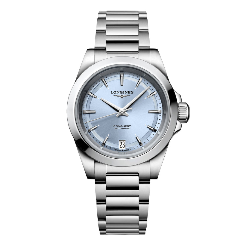 The Longines Conquest features a stainless steel case, light blue dial, silver hour markers, automatic movement, and a date display at 6 o’clock.