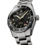 The Longines Spirit Zulu Time, a stainless steel wristwatch with black dial, luminous hands and numerals, date at 6 o’clock, GMT calibre, and rotating bezel is shown angled.
