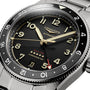 Close-up of the Longines Spirit Zulu Time, an automatic GMT wristwatch featuring a black dial, gold accents, date display, and dual time functionality with a red arrow hand.