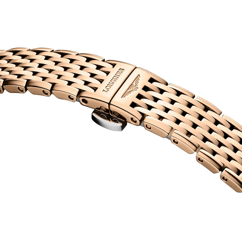 Close-up of a gold-tone metal bracelet from the La Grande Classique de LONGINES watch, featuring a clasp engraved with the Longines logo and name.