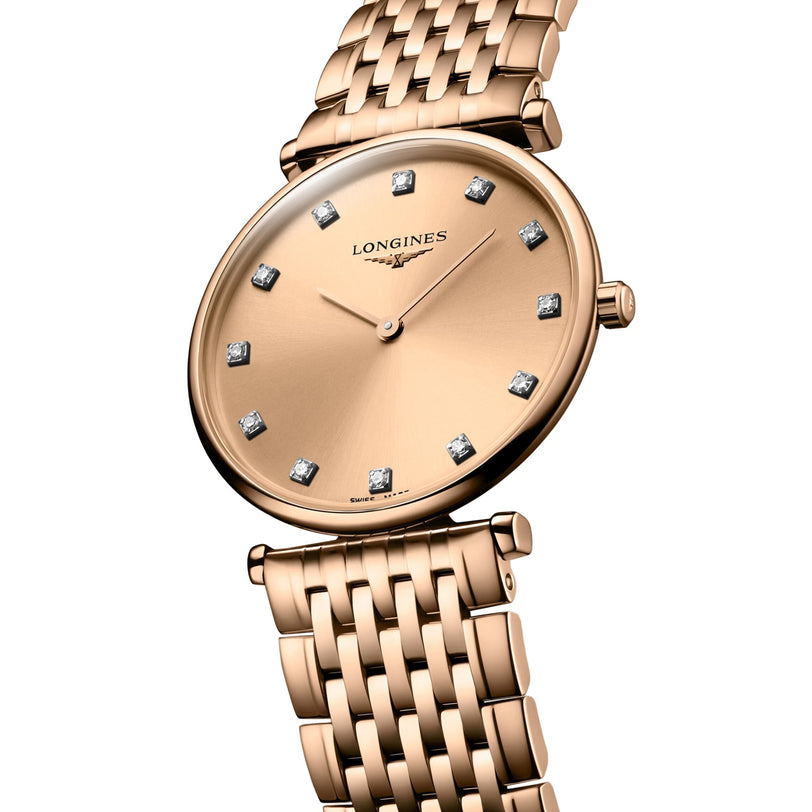 The Longines La Grande Classique de LONGINES features a gold round face, diamond hour markers, slim hands, and a gold link bracelet, beautifully presented against a white background.