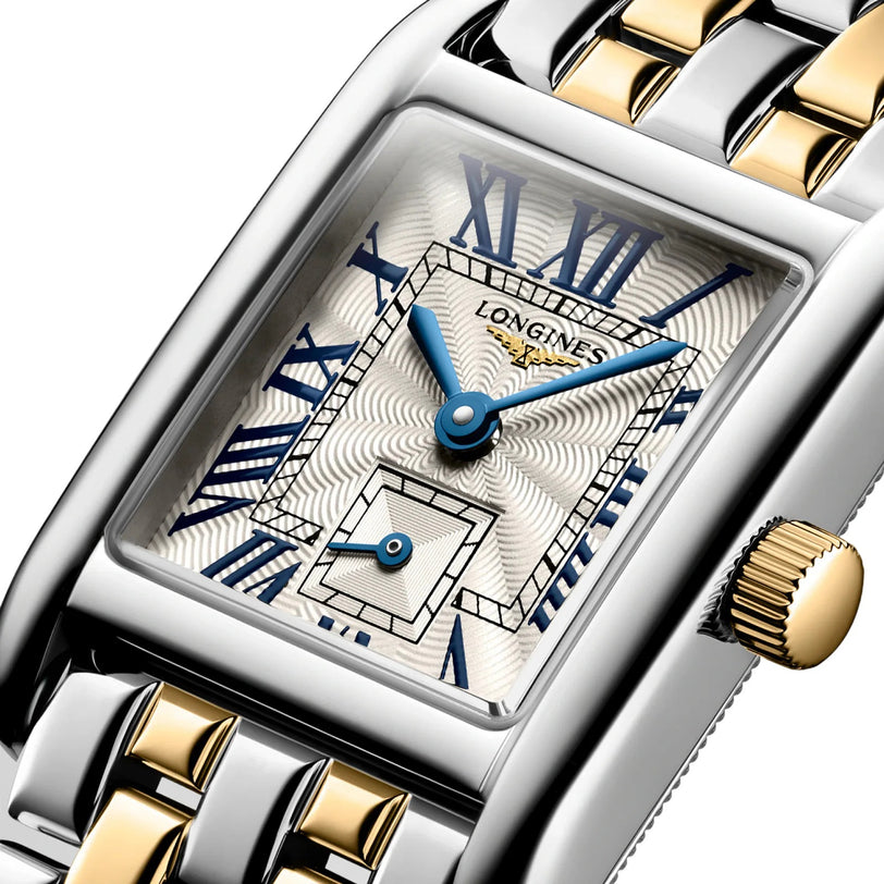 Close-up of the Longines Mini DolceVita watch featuring a rectangular case, silver and gold bracelet, textured silver dial, blue hands, and Roman numeral markers—a symbol of modern elegance.