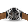 Close-up of the Tissot Le Locle Powermatic 80’s transparent case back displays its mechanical movement and engraved details, with brown leather straps showcasing Swiss craftsmanship from Le Locle, Jura Mountains.