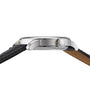 Side view of the Tissot Le Locle Powermatic 80, a silver wristwatch with a black leather strap and a crown engraved with T, inspired by Le Locle in the Swiss Jura Mountains.