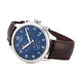 A Tissot Chrono XL Classic wristwatch with a blue chronograph dial, silver case, and brown leather strap is elegantly displayed at an angle on a white background.