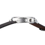 Side view of the Tissot Chrono XL Classic, a luxury watch featuring a silver case, round pushers, engraved crown, and a dark brown leather strap.