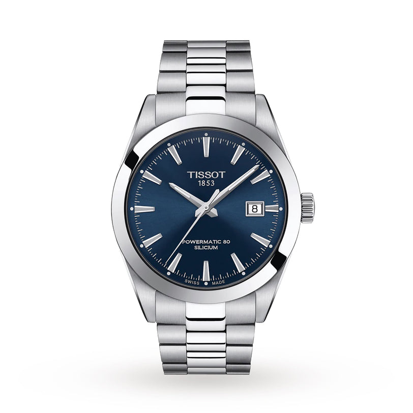 The Tissot Gentleman Powermatic 80 Silicium is a silver wristwatch with a blue dial, silver hour markers, date window at 3 o’clock, and a stainless steel case and bracelet.