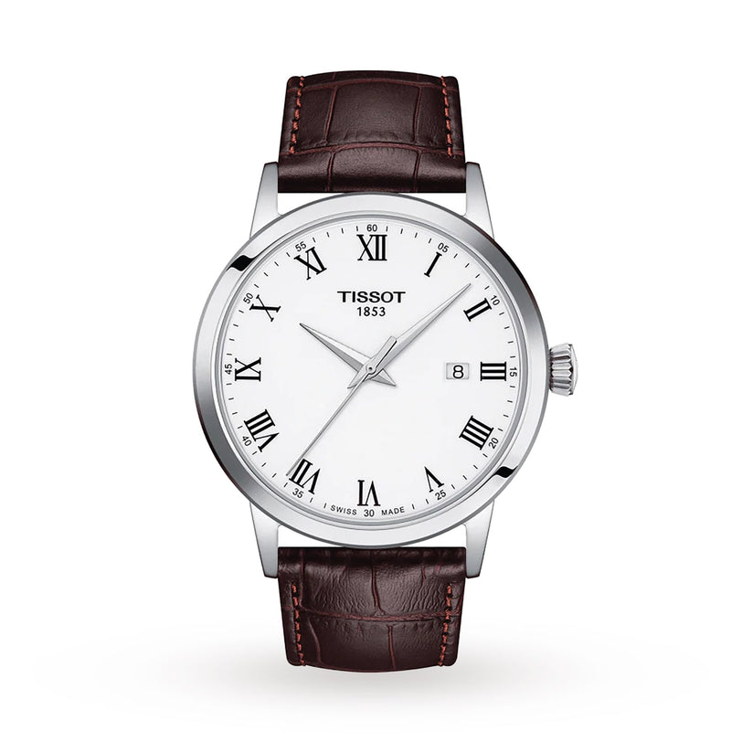 The Tissot Classic Dream features a white dial with Roman numerals, date window at 3 o’clock, Swiss quartz movement, silver case, and brown leather strap.