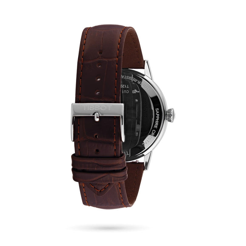 Back view of the Tissot Classic Dream watch, featuring a brown leather strap, silver Tissot-engraved buckle, and visible stainless steel case and crown—displaying refined craftsmanship.