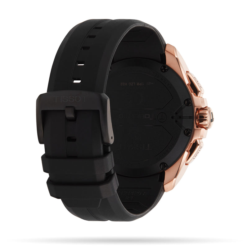A close-up of the Tissot T-Touch Connect Solar wristwatch showcases its black rubber strap, rose gold antimagnetic titanium case, clasp, and detailed back engraving.