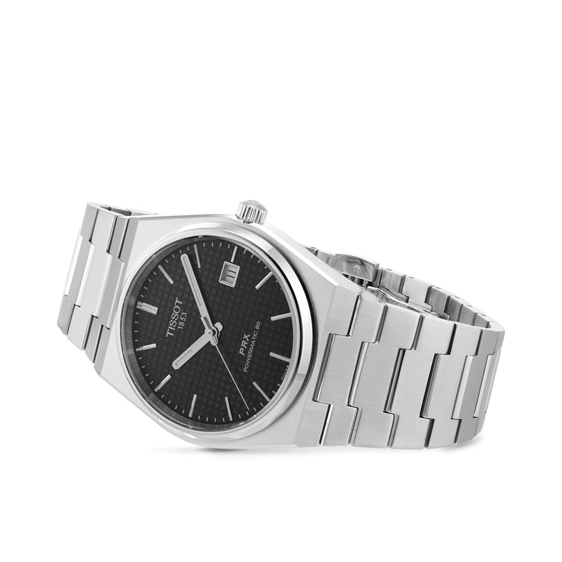Tissot PRX Powermatic 80 wristwatch featuring a black dial, date display, and metal link bracelet, shown on a white background.