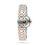 A silver and rose gold Tissot Bellissima Automatic wristwatch is shown from the back, featuring the brand name and 1853 on the clasp—an exquisite display of luxury and style from Tissot.
