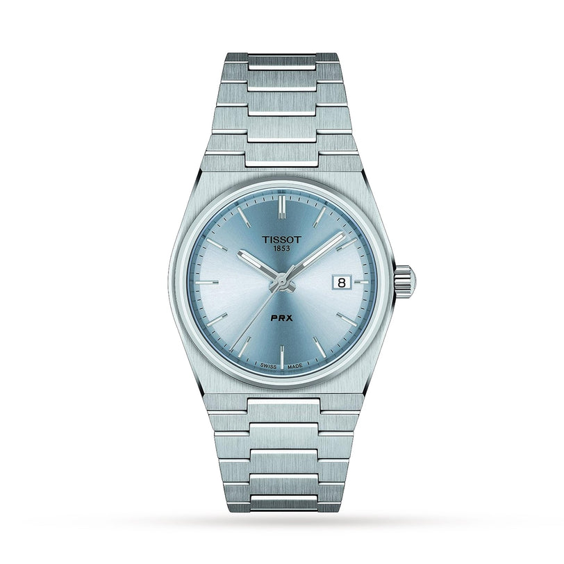 The Tissot PRX is a stainless steel wristwatch featuring a light blue dial, silver hour markers, Swiss quartz movement, date window at 3 oclock, and a brushed bracelet, all in a sleek 1970s-inspired design.