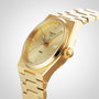 The Tissot PRX gold luxury watch features a metal bracelet, Swiss quartz movement, date display at 3 o’clock, and a minimalist design, shown on a light background.