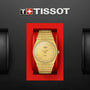 A Tissot PRX gold wristwatch with a stainless steel case is showcased in a red box beneath the Tissot logo on a black background.