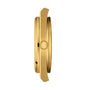 Side view of the Tissot PRX Powermatic 80 gold case with a round crown featuring a raised T logo, highlighting its refined design and advanced Nivachron hairspring.