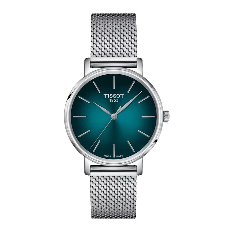 The Tissot Everytime wristwatch features a green gradient dial, silver hour markers, and a silver mesh band—an ideal classic or stylish choice, shown on a white background.