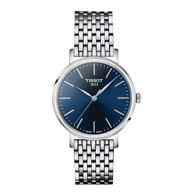 The Tissot Everytime wristwatch features a silver metal link band, round blue dial, silver hour markers, and TISSOT 1853 branding—an elegant timepiece that exemplifies the timeless style of the Everytime collection.