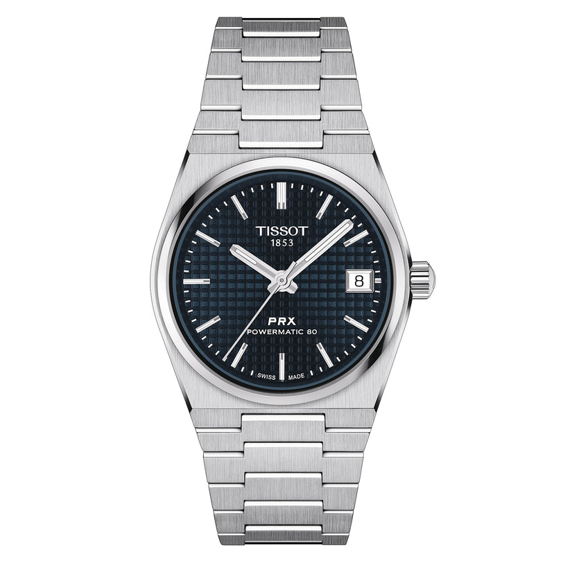 The Tissot PRX Powermatic 80 features a stainless steel case, blue dial with silver markers, date at 3 o’clock, and a sleek silver metal bracelet.