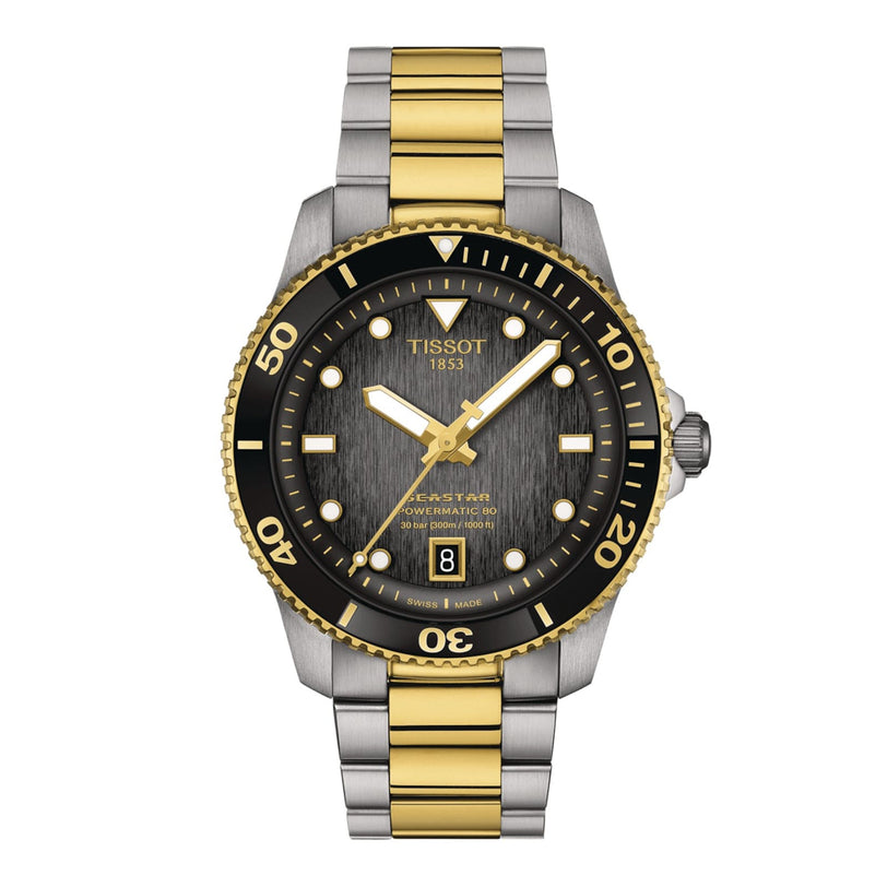 The Tissot Seastar 1000 Powermatic 80 features a two-tone gold and silver bracelet, black bezel, round dial with date at 6 oclock, and luminous hands and markers enhanced by Super-LumiNova.