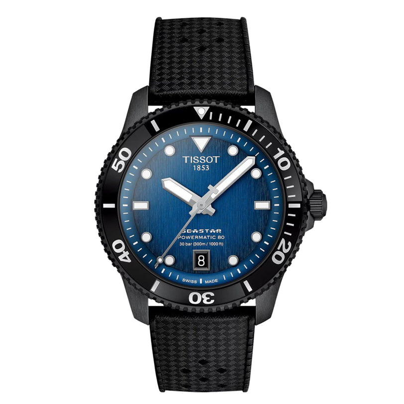 The Tissot Seastar 1000 Powermatic 80 is an automatic watch with a blue gradient dial, black bezel, date at 6 o’clock, and a textured black strap.