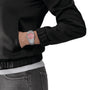 A person in a black jacket and jeans with their left hand in their pocket showcases the Tissot PRX, a retro watch featuring a pink face and stainless steel bracelet.