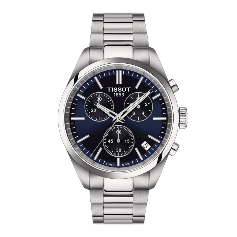 The Tissot PR 100 Chronograph features a stainless steel case, blue dial with three sub-dials, date at 4 o’clock, Super-LumiNova® for visibility, and a metal link bracelet.