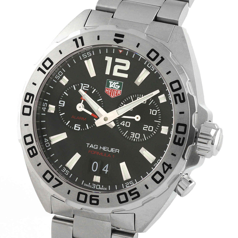 The TAG Heuer Formula 1 Date is a stainless steel sports watch with a black dial, luminous hour markers, three subdials, date display, and a metal bracelet.