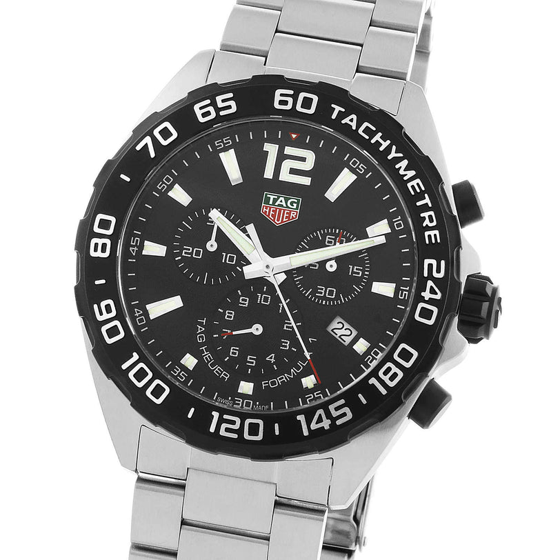 The TAG Heuer Formula 1 Chronograph features a stainless steel case, black tachymeter bezel, black dial with three subdials, date at 4 oclock, and a sleek silver bracelet.