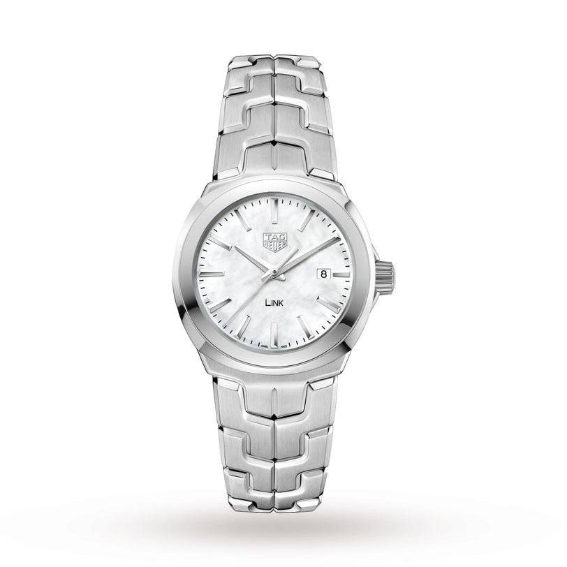 The TAG Heuer Link Date is a silver stainless steel wristwatch with a white dial, silver hour markers and hands, a date display at 3 o’clock, and the signature S-shaped bracelet.