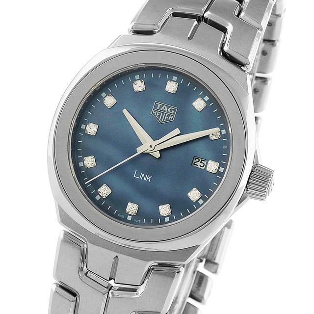The TAG Heuer Link Date is a silver ladies automatic wristwatch featuring a blue dial with diamond hour markers, date display at 3 o’clock, and a stainless steel bracelet—an elegant choice for any occasion.