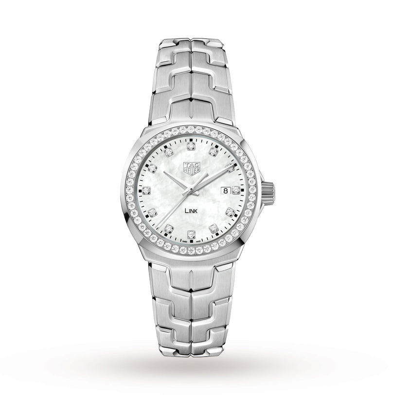 A TAG Heuer Link Date wristwatch with a diamond-set bezel, mother-of-pearl dial, date display at 3 o’clock, and stainless steel bracelet is shown on a white background.