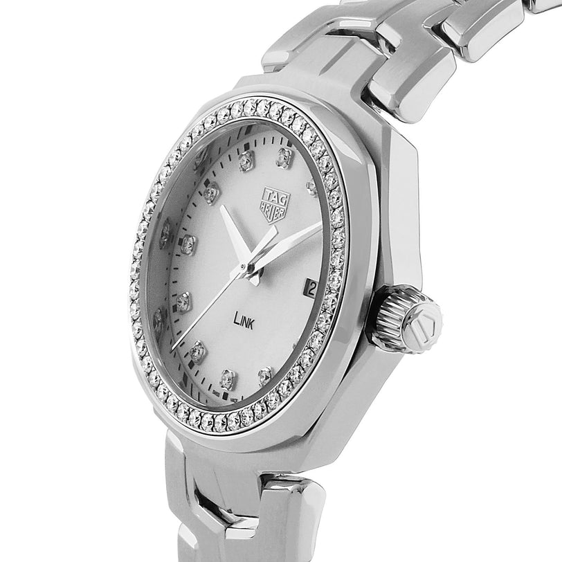 A TAG Heuer Link Date wristwatch featuring a silver metallic strap, mother-of-pearl dial, diamond bezel and hour markers, plus a date display at 3 o’clock.