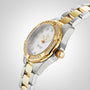 The TAG Heuer Aquaracer Date is a luxury silver and gold wristwatch with diamond accents, a white face, and a metal band, shown on a light background.