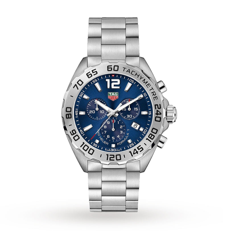 The TAG Heuer Formula 1 Chronograph is a silver watch with a blue dial, three subdials, tachymeter bezel, and metal link bracelet, shown on a white background.