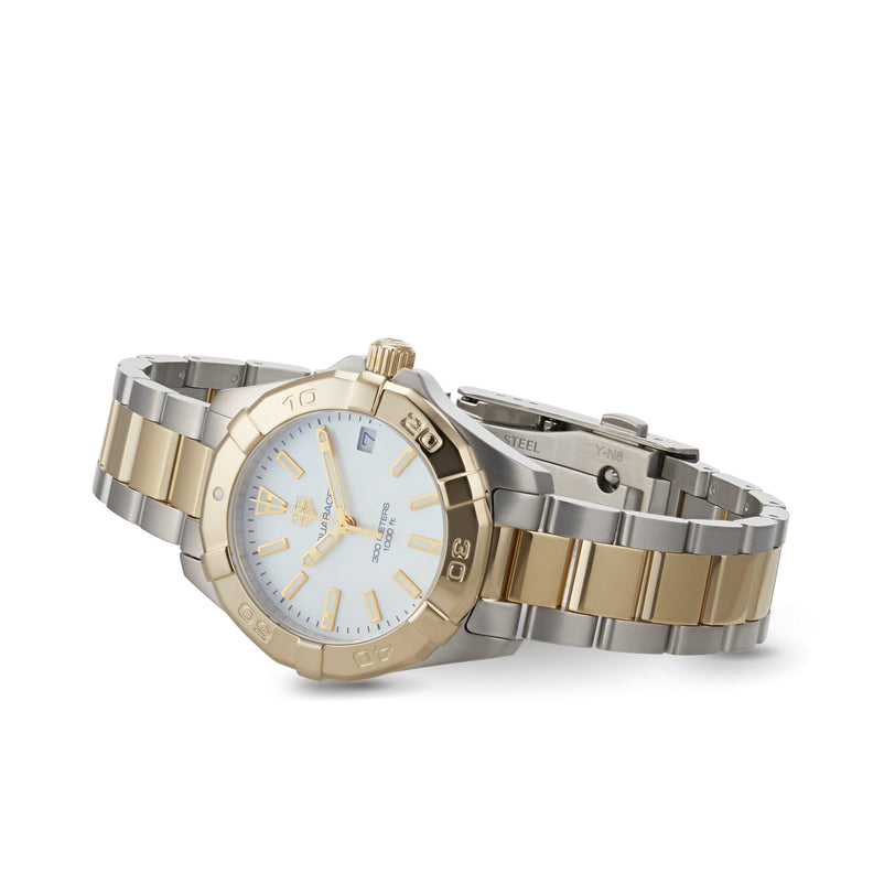 The TAG Heuer Aquaracer Date is a stainless steel and gold sports watch featuring a white mother-of-pearl dial, date display, and two-tone bracelet, pictured on a white background.