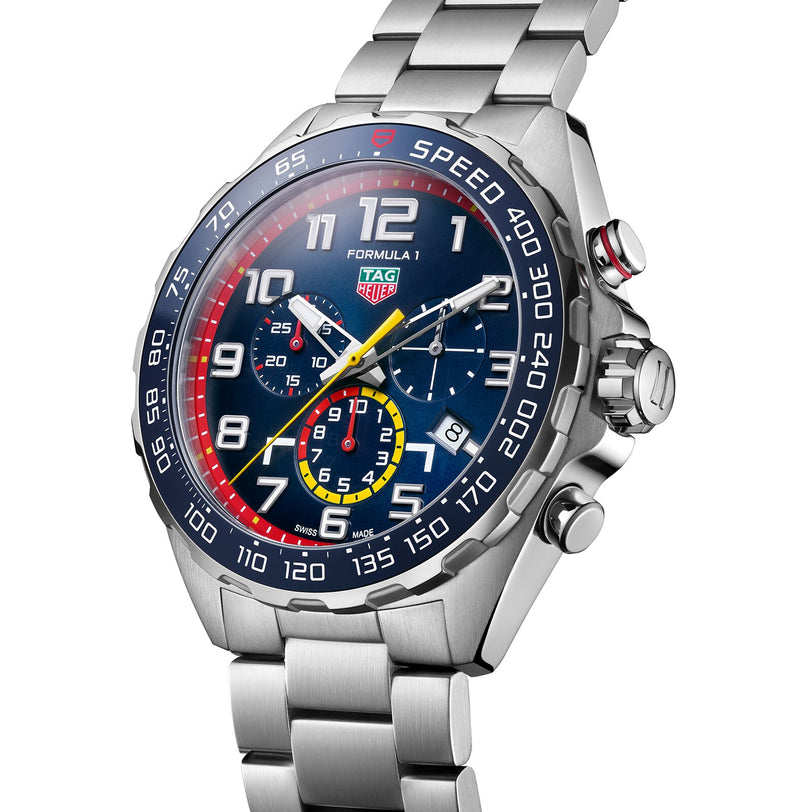 The TAG Heuer Special Edition Formula 1 Chronograph x Red Bull Racing features a blue dial, multicolored subdials, and a stainless steel bracelet, shown from an angled perspective.