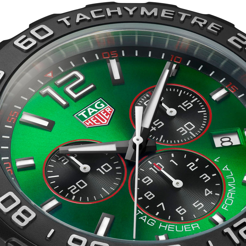 Close-up of a green TAG Heuer Formula 1 Chronograph watch face featuring three subdials, a date window at 4 o’clock, and TACHYMETRE on the black bezel, powered by precise quartz movement.