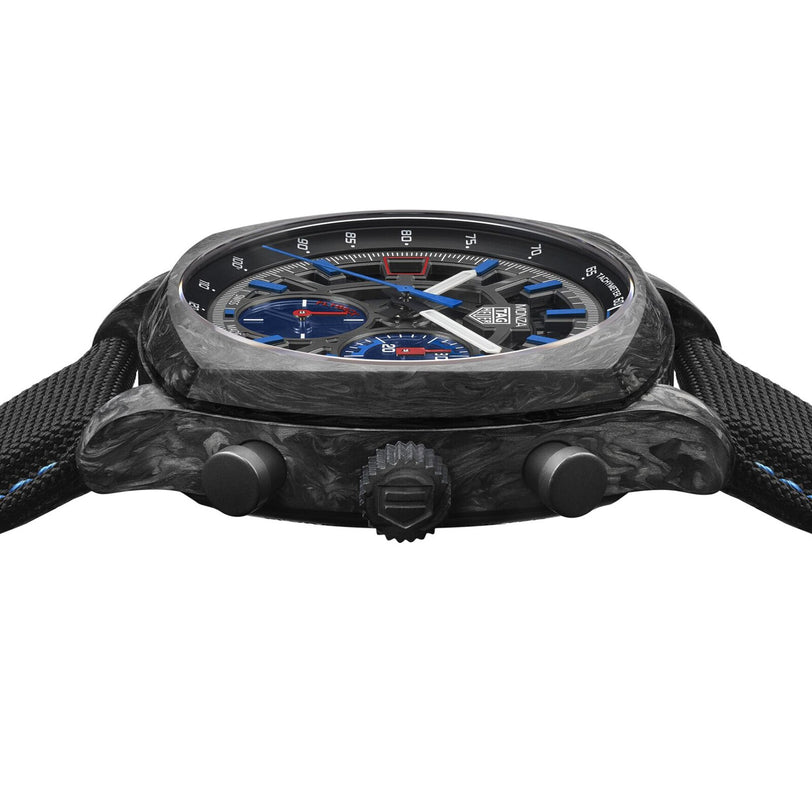 Close-up side view of the TAG Heuer Monza Flyback Chronometer, featuring a black marbled case and a blue dial.