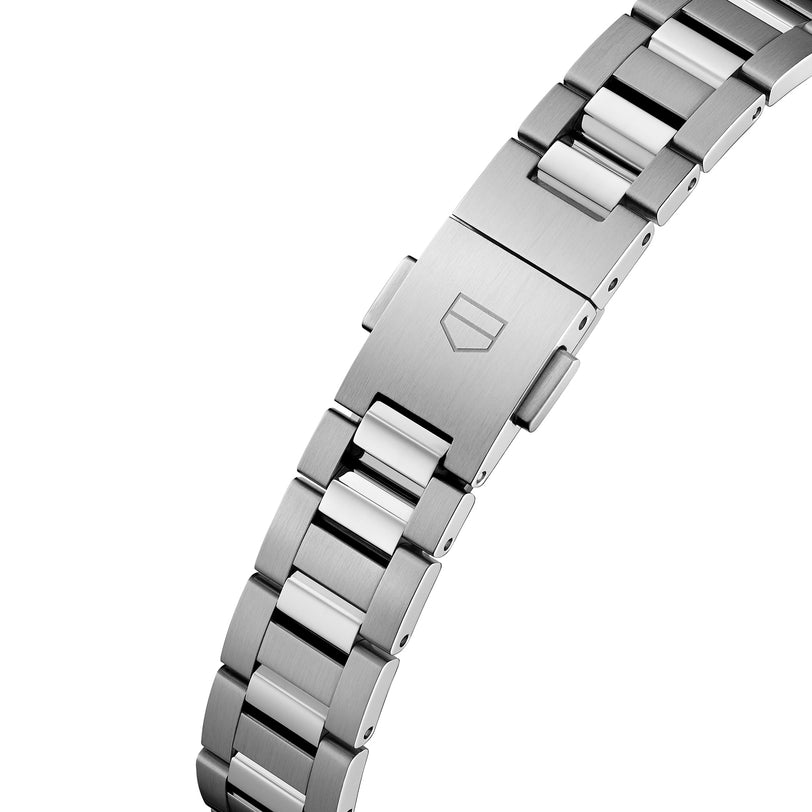 Close-up of a TAG Heuer Carrera Date stainless steel bracelet with polished center links, a brushed clasp engraved with the shield logo, and powered by the Calibre 9 automatic movement.